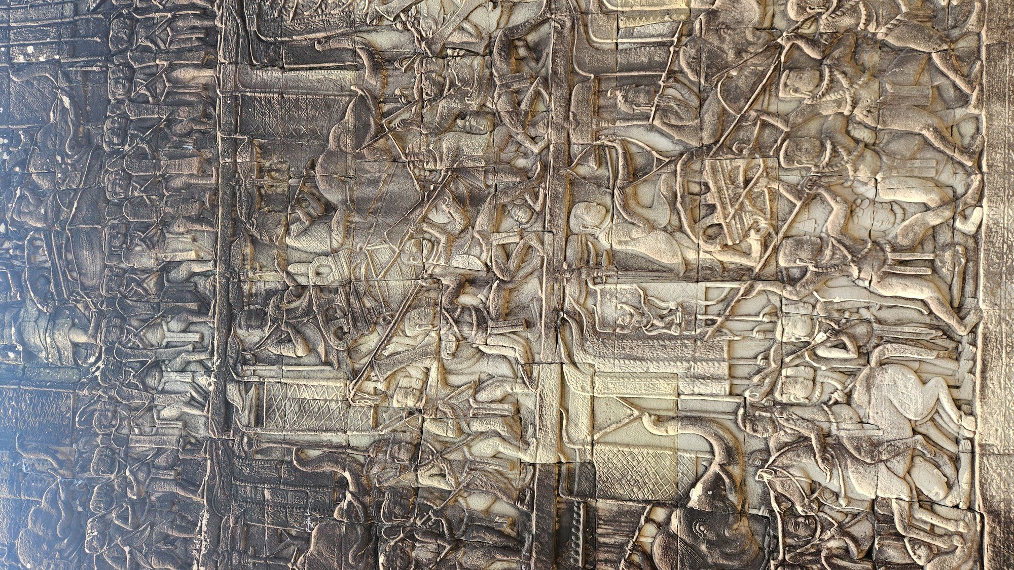 A carved battle scene in the bas-reliefs of Angkor