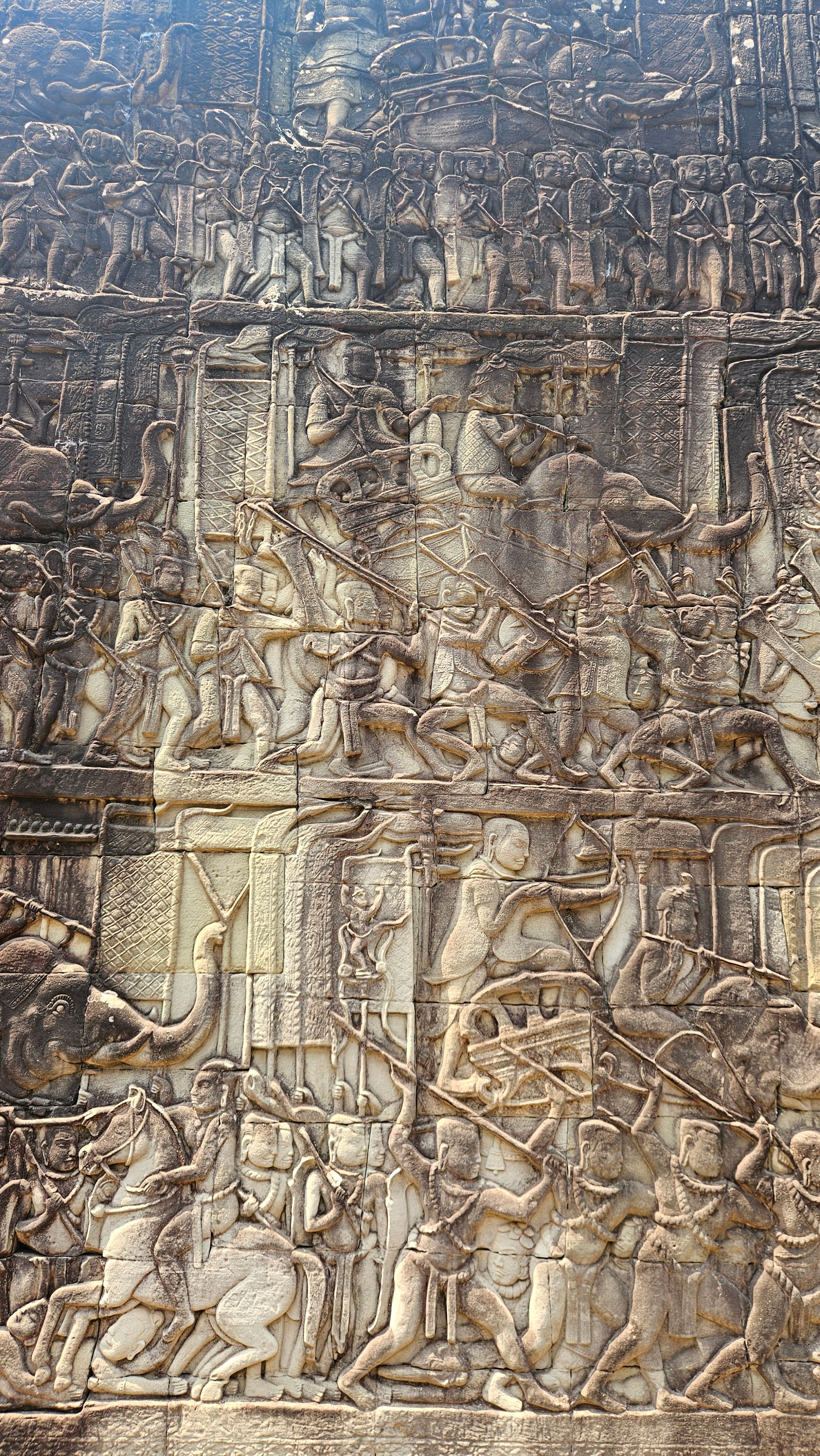 A carved battle scene in the bas-reliefs of Angkor