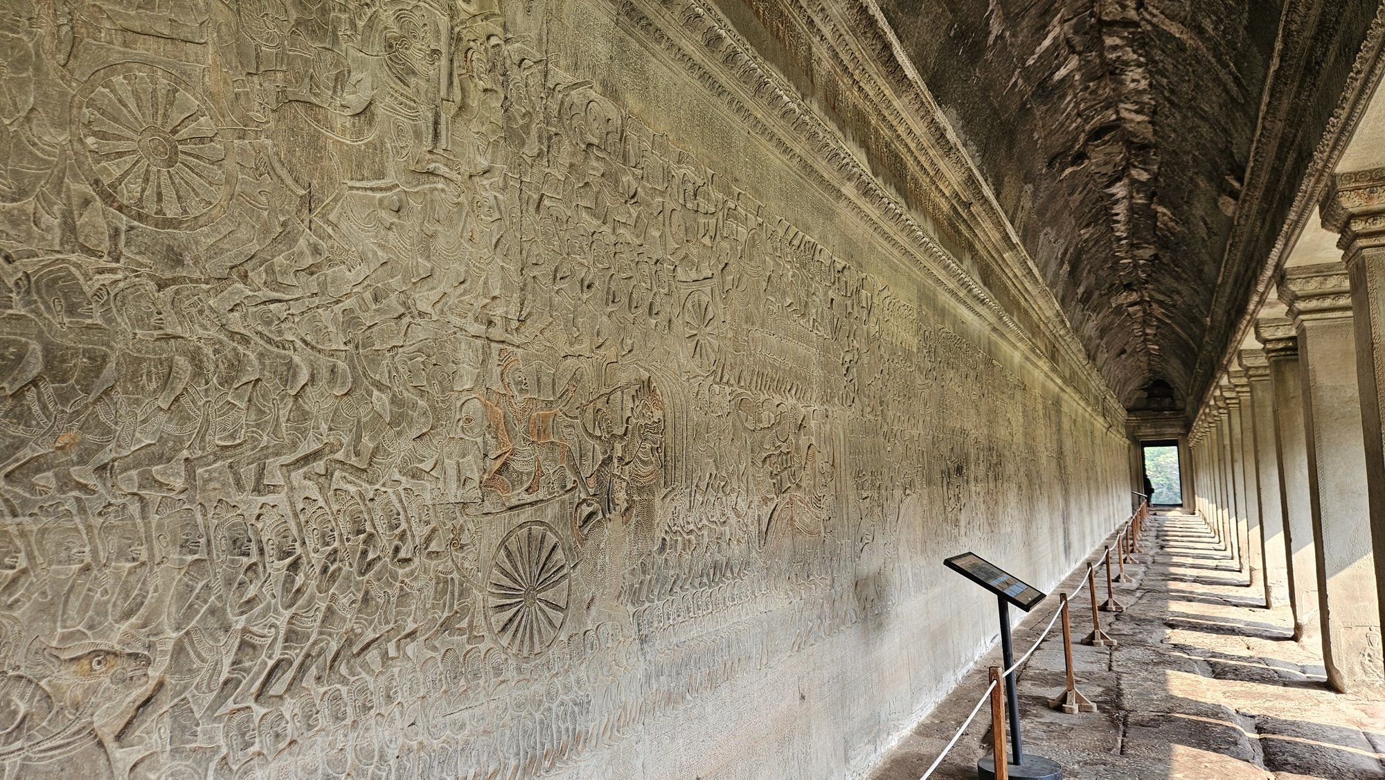 The bas-relief gallery of Angkor Wat, its carved wall running the length of the corridor