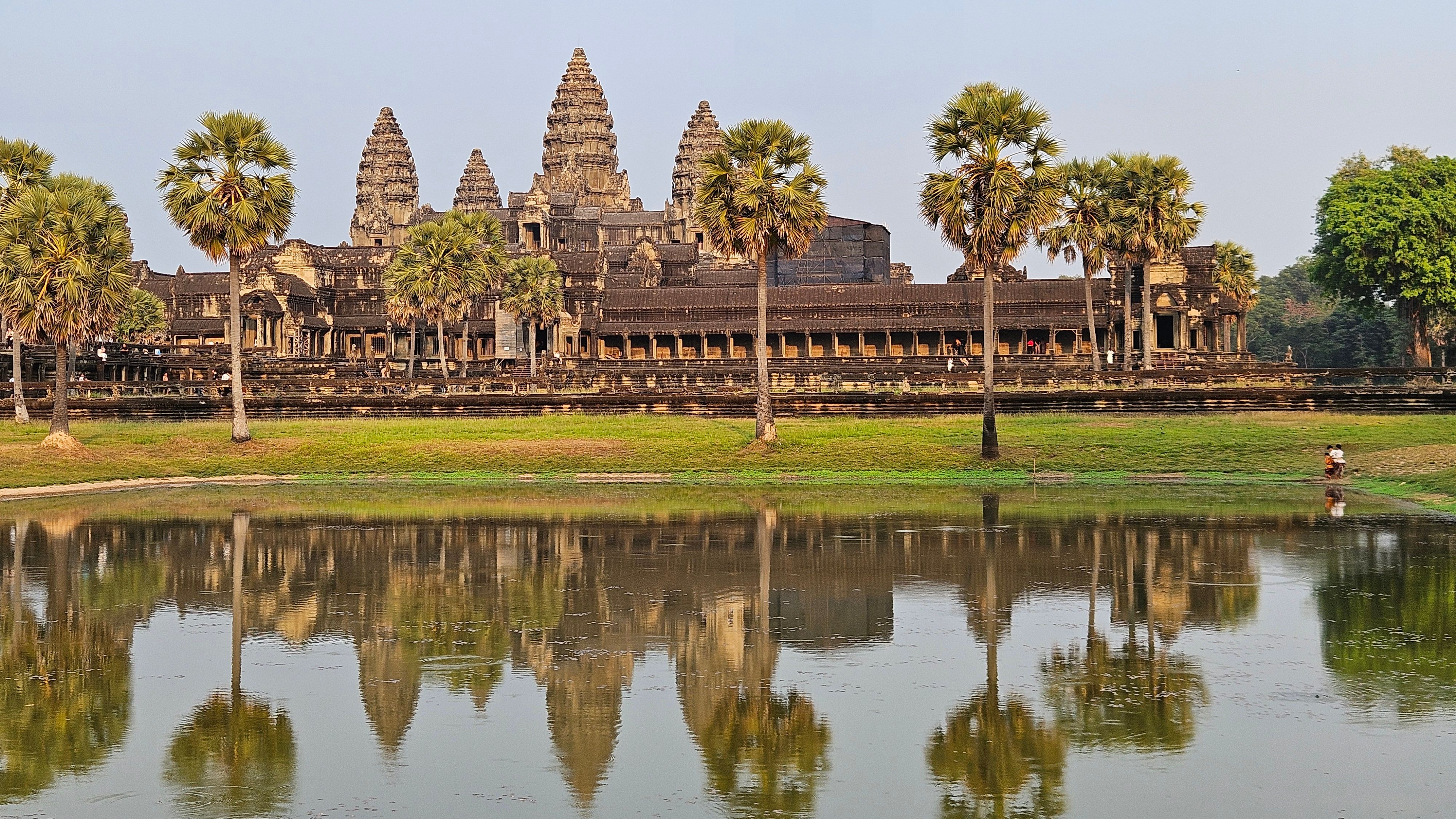 Angkor Wat mirrored in the still water of its vast moat