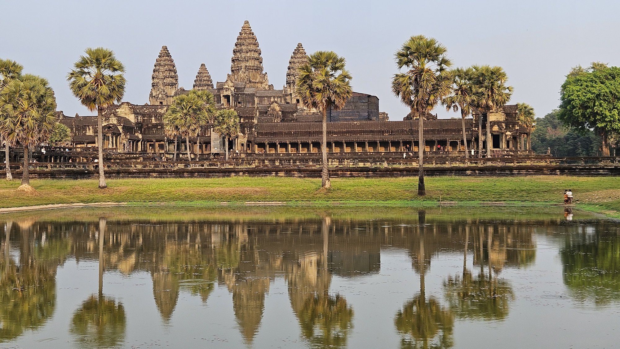 Angkor Wat mirrored in the still water of its vast moat