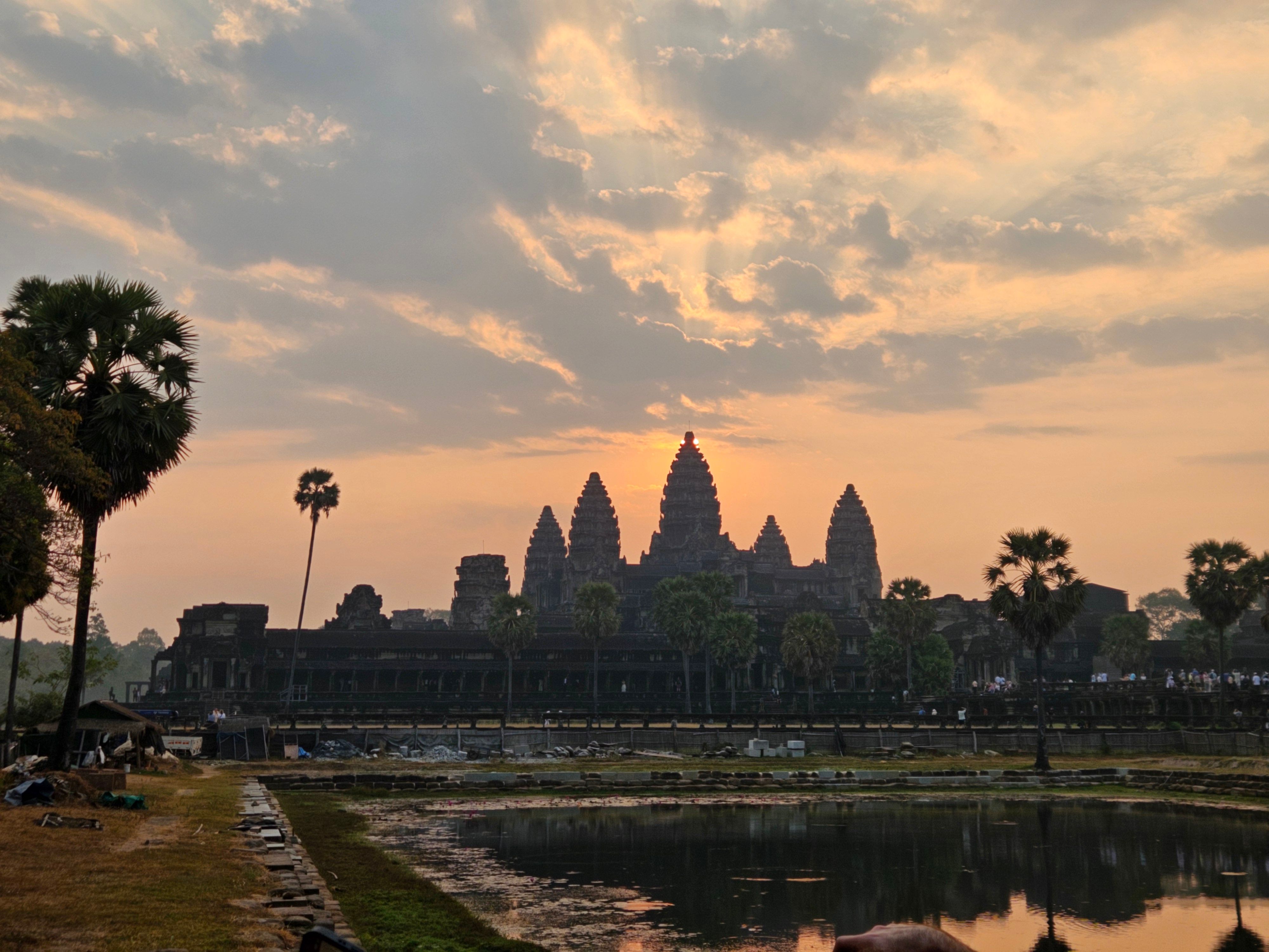 Angkor Wat at sunrise, its towers reflected in the pond, Siem Reap, Cambodia