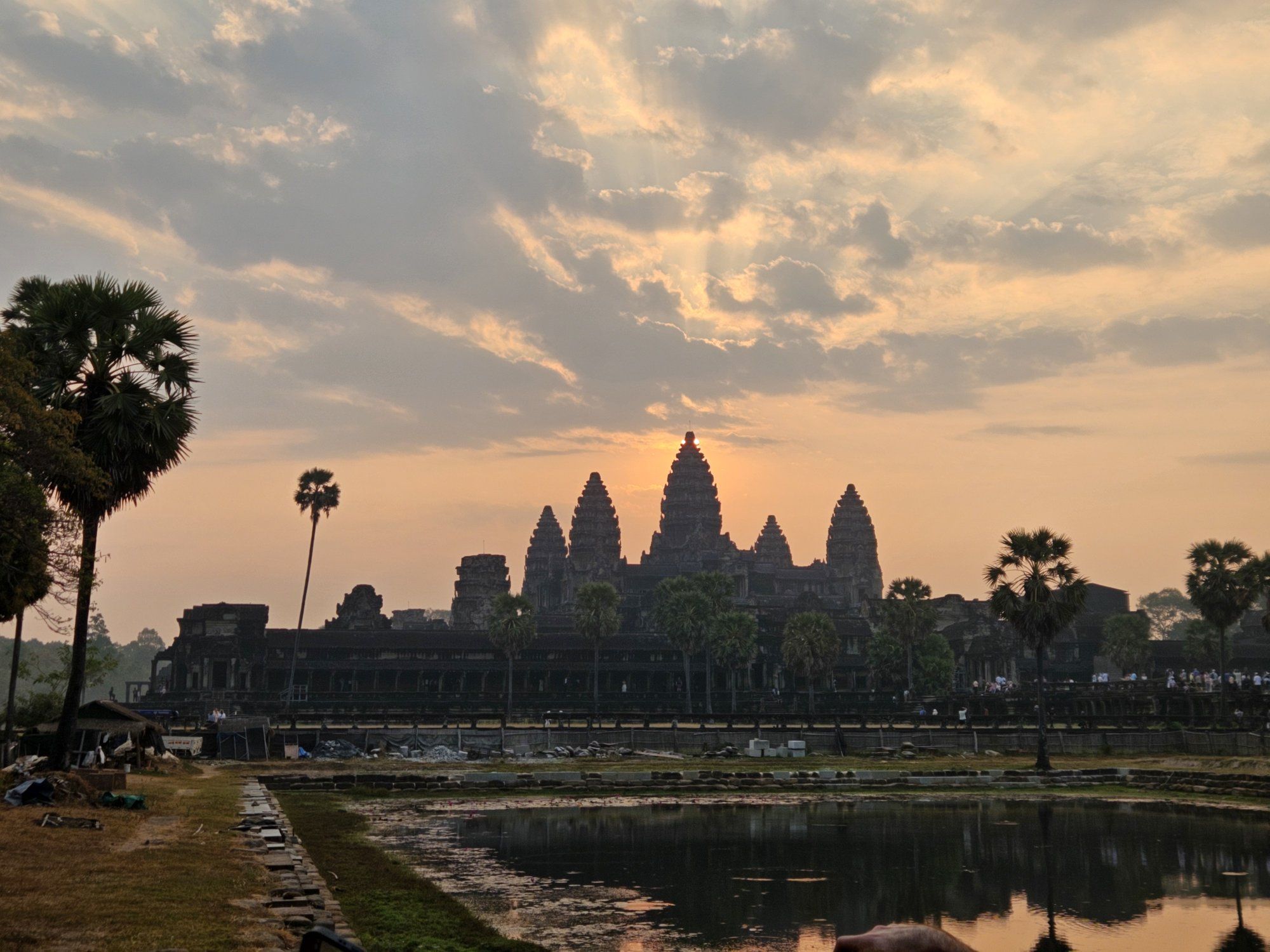 Angkor Wat at sunrise, its towers reflected in the pond, Siem Reap, Cambodia