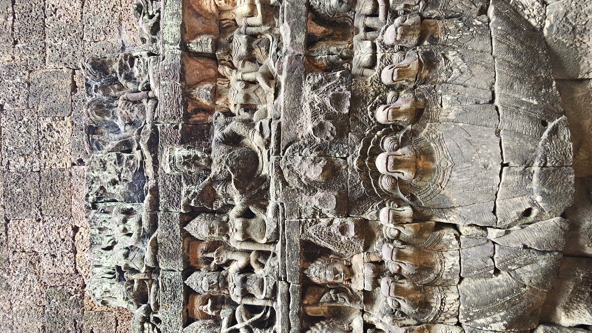 A row of carved devata figures on a temple wall