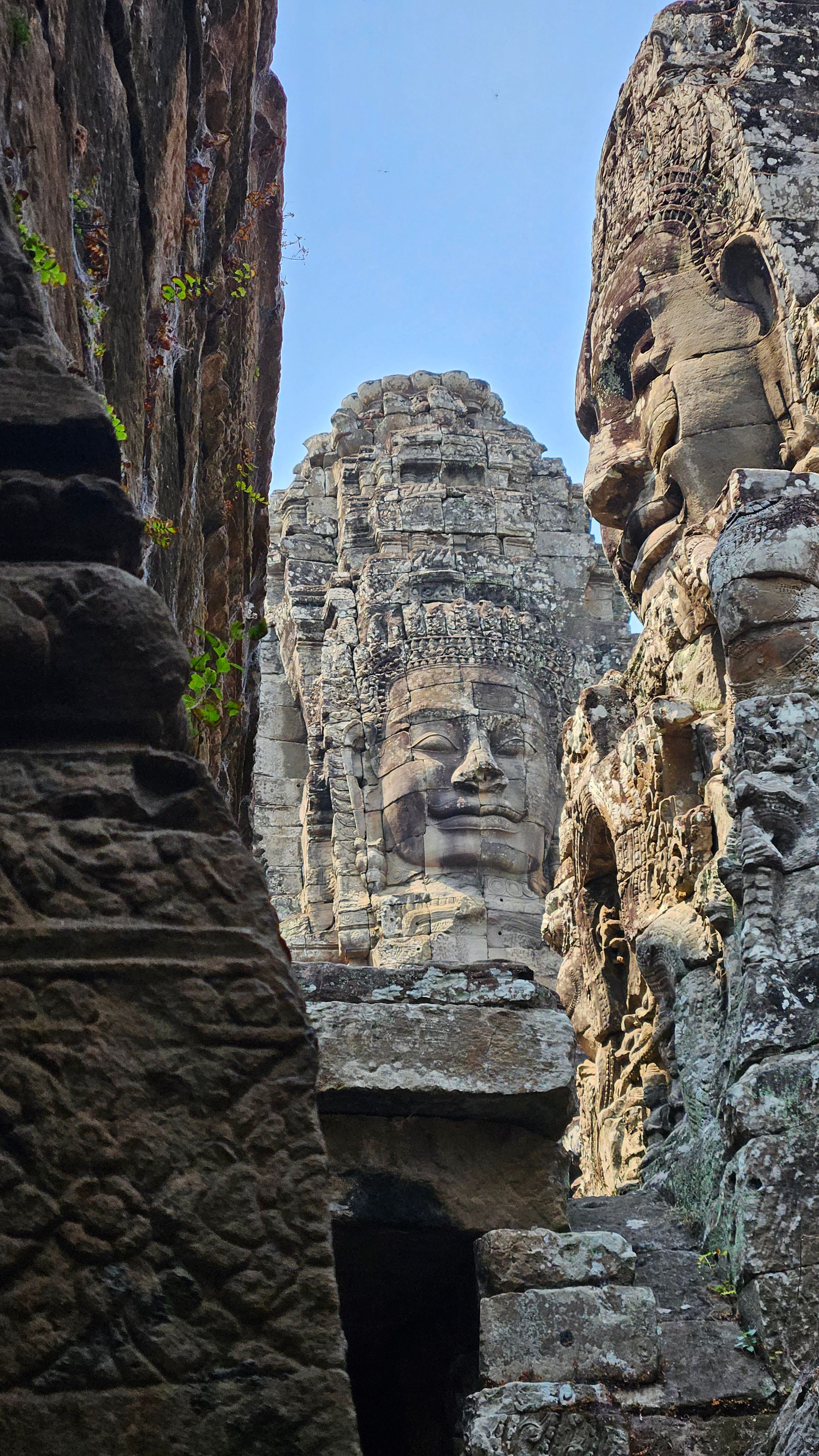 A giant carved stone face of the Bayon temple at Angkor Thom