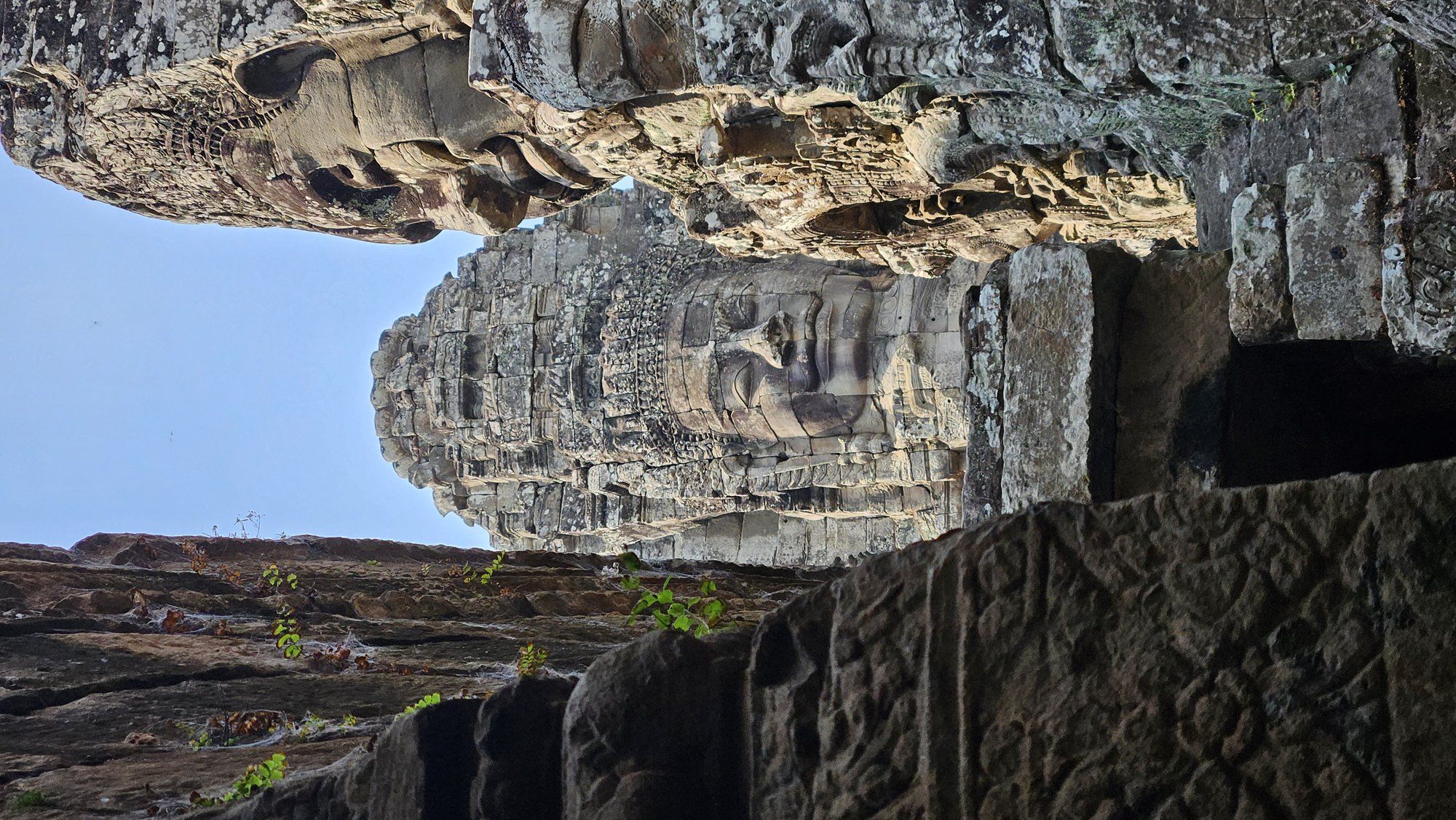 A giant carved stone face of the Bayon temple at Angkor Thom