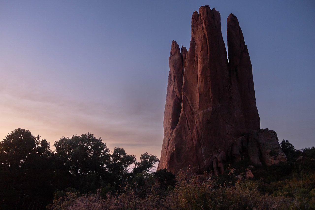 Red sandstone spires of Garden of the Gods glowing at sunrise beneath the Colorado Front Range