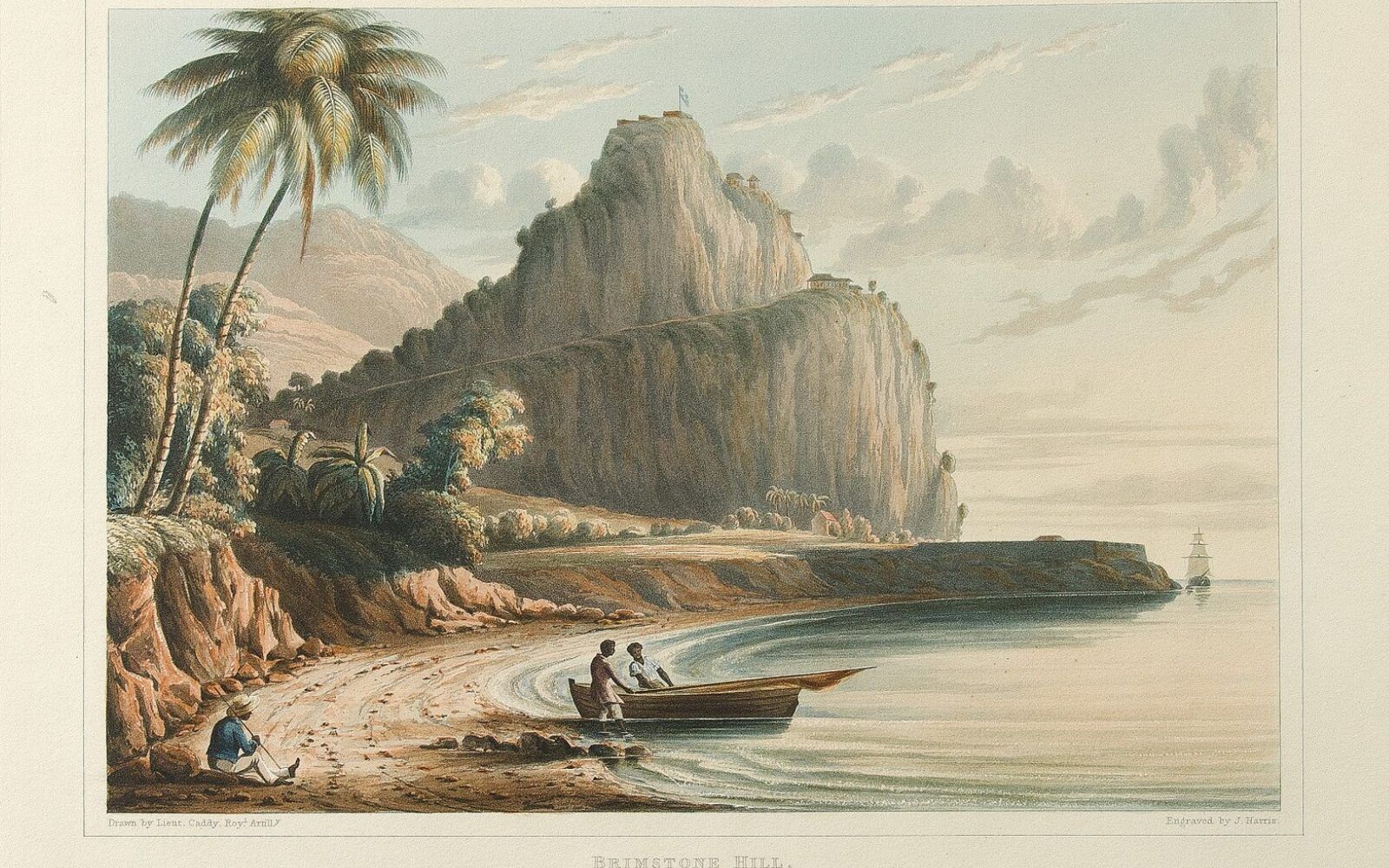 A palm-fringed Caribbean beach on Nevis looking across the narrows to the green peak of Saint Kitts