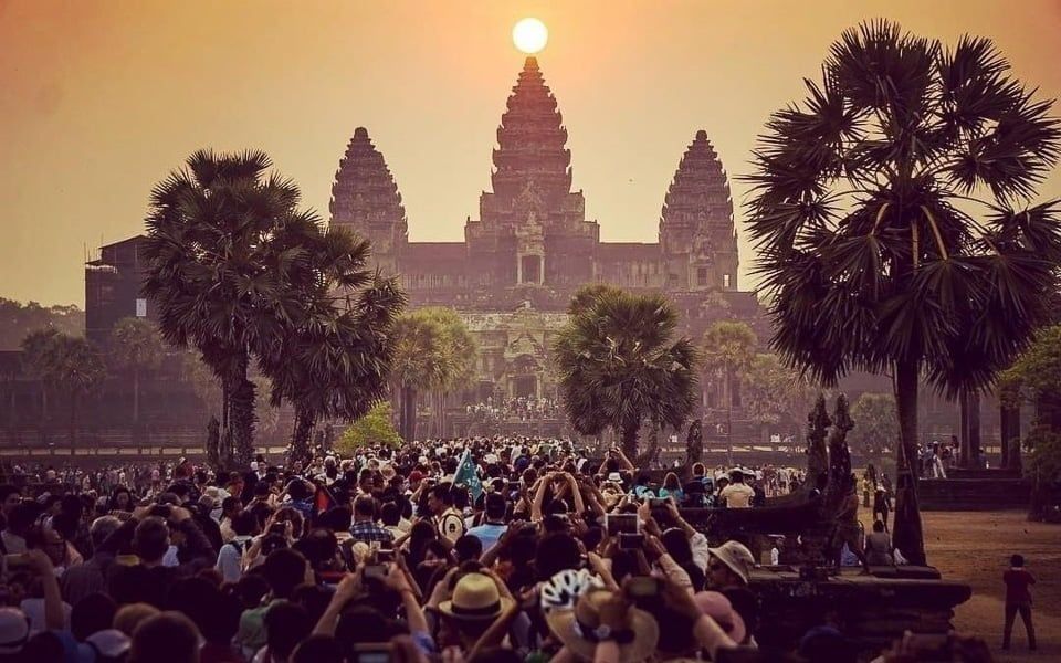 A traveller exploring the corridors of an Angkor temple